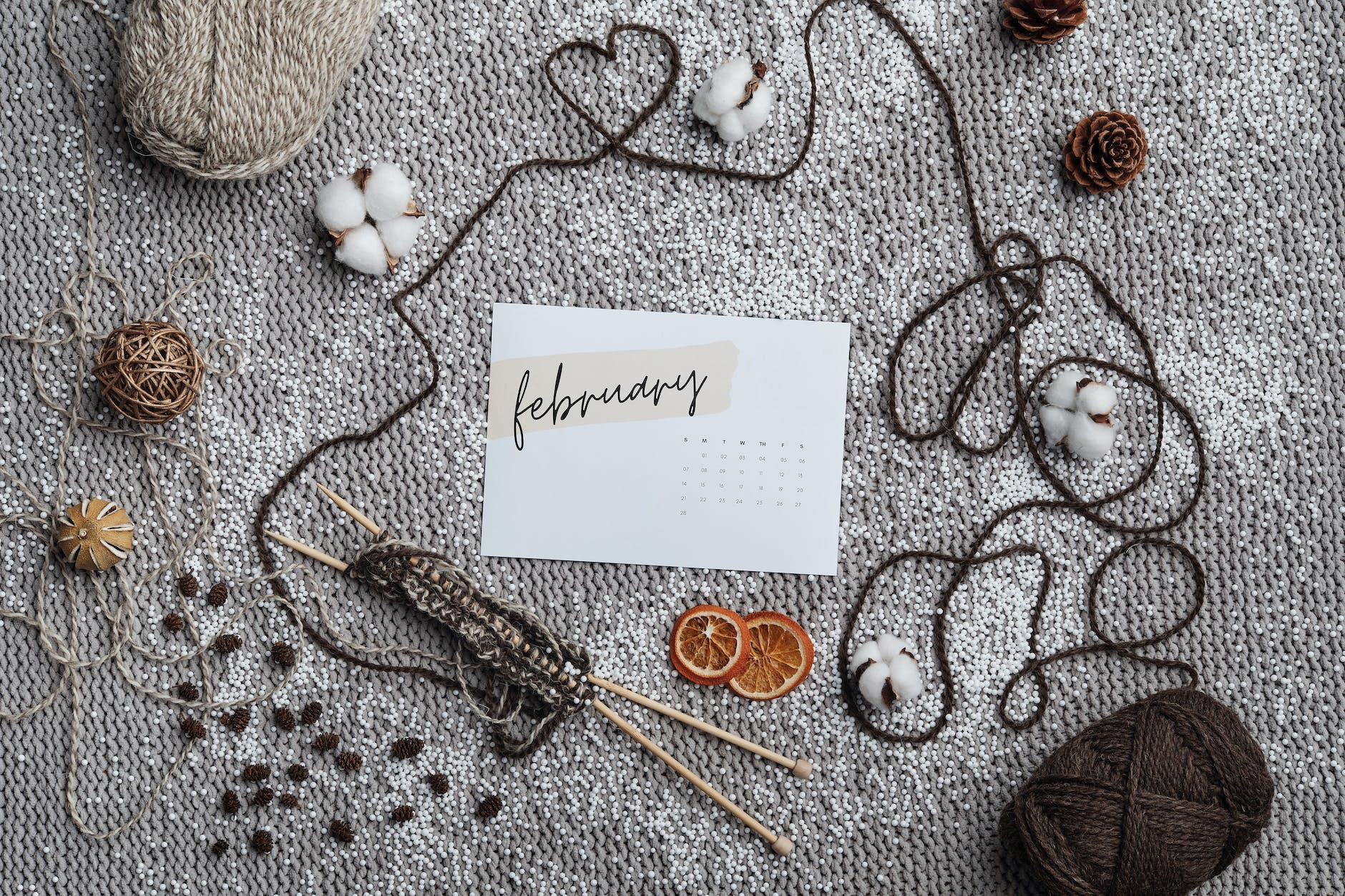 flatlay of crocheting objects on a gray surface